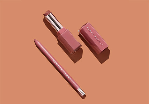 Open product shot of Traced Out Lip Liner and Gloss Bomb Sticks in shade RiRi. Open product shot of Traced Out Lip Liner and Gloss Bomb Sticks in shade RiRi.